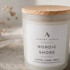 Closeup of Nordic Shore Candle. Label reads Nordic Shore. Coastal. Clean. Fresh. Where sea air meets driftwood calm.